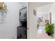 Hallway laundry area features stacked washer and dryer and leads to sunlit bedroom with neutral decor at 4400 37Th S St # 2, St Petersburg, FL 33711