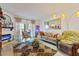Sunlit living room featuring stylish decor, comfortable seating, and a modern fireplace at 4400 37Th S St # 2, St Petersburg, FL 33711