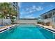Sparkling in-ground pool surrounded by lounge seating and tropical landscaping; perfect for hot summer days at 4400 37Th S St # 2, St Petersburg, FL 33711