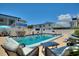 Relaxing community pool features comfortable lounge chairs, tables, and nearby condo buildings at 4400 37Th S St # 2, St Petersburg, FL 33711