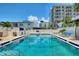 Inviting community pool surrounded by lounge chairs, palm trees, and modern condo buildings at 4400 37Th S St # 2, St Petersburg, FL 33711