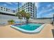 Relaxing outdoor swimming pool with ample seating surrounded by lush tropical palms at 4400 37Th S St # 2, St Petersburg, FL 33711