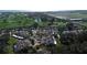 An aerial shot of a neighborhood surrounding a golf course and a body of water on a sunny day at 4635 La Jolla Dr, Bradenton, FL 34210