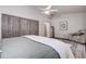 Bright bedroom featuring wood-look floors, ceiling fan, and a stylish sliding barn door closet at 4635 La Jolla Dr, Bradenton, FL 34210