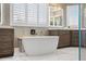 Bright bathroom features a soaking tub, dual vanities, and white marble floors at 555 5Th Ne Ave # 711, St Petersburg, FL 33701