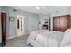 Spacious bedroom with a walk-in closet, ensuite bathroom, and cozy carpet is a welcome retreat at 555 5Th Ne Ave # 711, St Petersburg, FL 33701