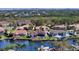 Beautiful aerial view showcasing waterfront homes, lush greenery, and a skyline in the distance at 6014 Mariners Watch Dr, Tampa, FL 33615