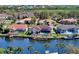 Aerial view showcasing waterfront homes with private docks, pools, and lush landscaping in a serene community at 6014 Mariners Watch Dr, Tampa, FL 33615