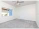 Bedroom featuring neutral carpet, a ceiling fan, and a bright window at 6014 Mariners Watch Dr, Tampa, FL 33615