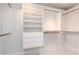 Walk-in closet featuring white shelving, drawers, and ample hanging space at 6014 Mariners Watch Dr, Tampa, FL 33615