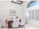 Elegant dining room with high ceilings, plantation shutters, and modern lighting at 6014 Mariners Watch Dr, Tampa, FL 33615