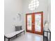 Bright foyer featuring a tiled floor, a bench, a glass front door and transom windows at 6014 Mariners Watch Dr, Tampa, FL 33615