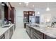 Well-lit kitchen with stainless steel appliances, lots of cabinet space, tile floors and a large island with granite countertops at 6014 Mariners Watch Dr, Tampa, FL 33615