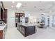 Spacious kitchen featuring an island with granite countertop, stainless appliances, and an adjacent dining area at 6014 Mariners Watch Dr, Tampa, FL 33615