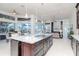 Bright, open kitchen featuring a large island, granite countertops, and stainless steel appliances, perfect for entertaining at 6014 Mariners Watch Dr, Tampa, FL 33615
