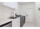 Bright laundry room featuring a sink, modern washer and dryer, and ample storage space at 6014 Mariners Watch Dr, Tampa, FL 33615