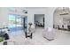 Bright living room featuring light hardwood floors, sliding glass doors to pool, and open concept kitchen and dining at 6014 Mariners Watch Dr, Tampa, FL 33615