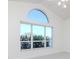 Living room featuring a unique arched window that allows ample natural light to filter in at 6014 Mariners Watch Dr, Tampa, FL 33615