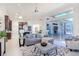 An open concept space featuring a modern living room, dining and kitchen area with pool views at 6014 Mariners Watch Dr, Tampa, FL 33615