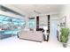Bright and airy living room featuring large windows with views of the pool and built-in shelving at 6014 Mariners Watch Dr, Tampa, FL 33615