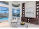Cozy living room space featuring built-in shelving, an accent chair and views of the pool at 6014 Mariners Watch Dr, Tampa, FL 33615