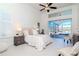 Bright main bedroom featuring a ceiling fan, white walls, and screened-in porch access at 6014 Mariners Watch Dr, Tampa, FL 33615