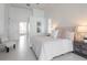 Airy main bedroom with light tile, a plush bed, and an ensuite bathroom visible in the background at 6014 Mariners Watch Dr, Tampa, FL 33615
