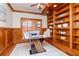 Charming home office with wood paneling, built-in bookshelves, and a stylish modern desk at 6014 Mariners Watch Dr, Tampa, FL 33615