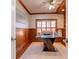 Traditional office with wood-trimmed walls, a ceiling fan, and a large window at 6014 Mariners Watch Dr, Tampa, FL 33615