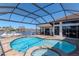 Enjoy the beautiful pool and spa, surrounded by an enclosed patio, with views of the canal and private dock at 6014 Mariners Watch Dr, Tampa, FL 33615