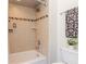 Bathroom shower with a showerhead, tiled walls and a white bathtub at 6014 Mariners Watch Dr, Tampa, FL 33615