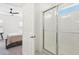 Bathroom featuring a glass-door shower and access to the primary bedroom at 6251 Camino Dr, Apollo Beach, FL 33572