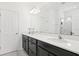 Bathroom with double vanity, white countertop, and black cabinets, plus a glass-door shower at 6251 Camino Dr, Apollo Beach, FL 33572