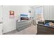Bedroom features a gray dresser with a TV, complementary decor, and a cozy, neutral-toned carpet at 6251 Camino Dr, Apollo Beach, FL 33572
