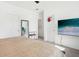Bright bedroom features a large bed, a mounted television, and ample closet space at 6251 Camino Dr, Apollo Beach, FL 33572