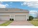 Home featuring a well-manicured front yard, garage, and brick-paved driveway at 6251 Camino Dr, Apollo Beach, FL 33572