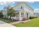 Charming two-story home with manicured lawn and inviting front porch at 6251 Camino Dr, Apollo Beach, FL 33572