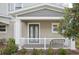 Close-up of the front porch with comfortable seating and attractive landscaping at 6251 Camino Dr, Apollo Beach, FL 33572