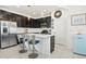 Kitchen island with seating and stainless steel appliances at 6251 Camino Dr, Apollo Beach, FL 33572