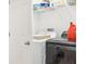 Functional laundry room with modern washer and dryer, plus storage shelves for supplies at 6251 Camino Dr, Apollo Beach, FL 33572