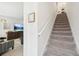 Bright, carpeted staircase with white railing leads to the upper level of this stylish home at 6251 Camino Dr, Apollo Beach, FL 33572