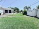 Spacious backyard featuring lush green grass and storage sheds perfect for outdoor activities at 6398 17Th N Pl, St Petersburg, FL 33710
