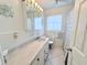 Bright bathroom featuring a tiled floor, single sink vanity, and decorative nautical accents at 6398 17Th N Pl, St Petersburg, FL 33710