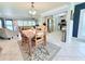 Dining area features neutral tones, tile flooring, and an open floor plan to the kitchen and living room at 6398 17Th N Pl, St Petersburg, FL 33710