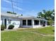 Charming home exterior with manicured lawn, blue and white accents, and a well-maintained landscape at 6398 17Th N Pl, St Petersburg, FL 33710