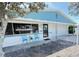 Charming single-story home featuring a blue trim and a well-maintained front yard with seating at 6398 17Th N Pl, St Petersburg, FL 33710