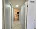 Hallway with tile flooring leading to dining room and a living room at 6398 17Th N Pl, St Petersburg, FL 33710