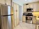 Efficient kitchen with stainless steel appliances and custom cabinets, designed for easy meal preparation and storage solutions at 6398 17Th N Pl, St Petersburg, FL 33710