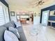 Inviting living room with tiled floors, offering a seamless transition to the dining and kitchen areas, enhanced by natural light at 6398 17Th N Pl, St Petersburg, FL 33710