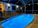 The enclosed in-ground pool features beautiful blue tiling and is lit up for nighttime swims at 6398 17Th N Pl, St Petersburg, FL 33710
